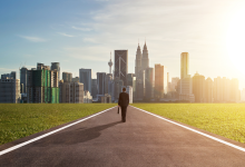 entrepreneur man walking towards kuala lumpur city