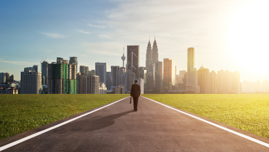 entrepreneur man walking towards kuala lumpur city