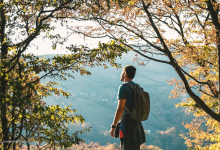 Man standing at peak of mountain